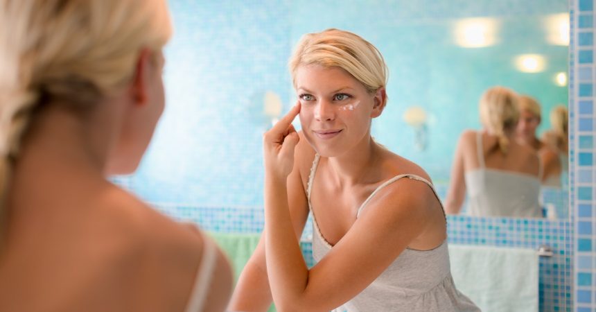 woman applying cleanser on her face